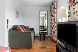 a living room with a couch and a flat screen tv at Landvetter Airport Hotel, Best Western Premier Collection in Landvetter