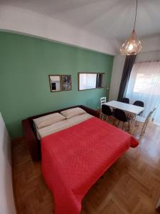 a bedroom with a bed and a table with a red blanket at Domus Cornelia in Rome