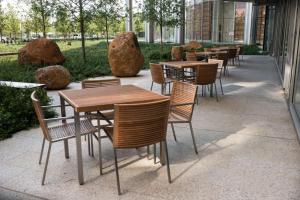 eine Gruppe von Tischen und Stühlen außerhalb eines Gebäudes in der Unterkunft Colcord Hotel Oklahoma City, Curio Collection by Hilton in Oklahoma City