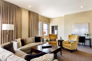 a living room with a couch and a table at Colcord Hotel Oklahoma City, Curio Collection by Hilton in Oklahoma City