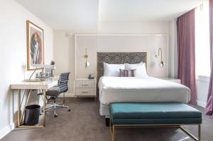 a hotel room with a bed and a desk at The Kelly Birmingham, Tapestry Collection By Hilton in Birmingham