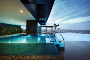 a swimming pool with a view of the water at Doubletree By Hilton Shah Alam I-City in Shah Alam