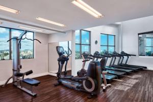 a gym with a row of treadmills and exercise bikes at Hilton Porto Alegre, Brazil in Porto Alegre