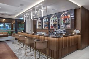 a bar in a restaurant with stools at Doubletree By Hilton Plovdiv Center in Plovdiv