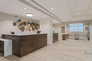 a lobby of a dental office with a smile sign on the wall at Homewood Suites By Hilton Panama City Beach, Fl in Panama City Beach