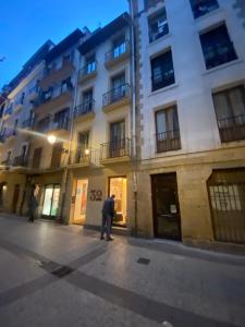 a man standing on a street in front of a building at 32 De Agosto ROOMS in Donostia-San Sebastián +45 photos
