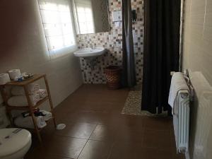 a bathroom with a sink and a toilet and a sink at Casa Portomeiro in San Román