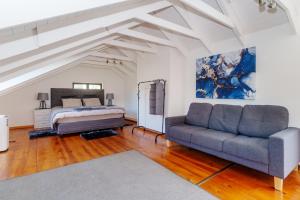 a living room with a bed and a couch at Hout Bay Gem - Elise Way in Hout Bay