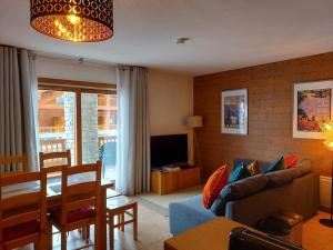 a living room with a couch and a table at La Reine des Prés in Sainte-Foy-Tarentaise