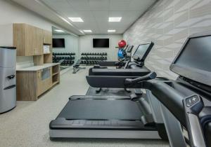 a gym with treadmills and a treadmill at Coast Rehoboth Beach, Tapestry Collection By Hilton in Rehoboth Beach