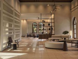 a lobby with couches and tables and chairs at Lindian Village Beach Resort, Curio Collection By Hilton in Kiotari