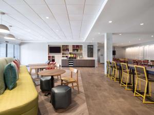 a cafeteria with tables and chairs and a counter at Home2 Suites By Hilton Santa Rosa Beach in Santa Rosa Beach