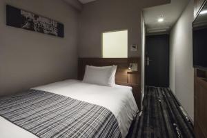 Postel nebo postele na pokoji v ubytování Hotel Sunroute Ginza