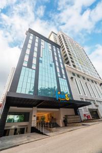 a tall building with a dinosaur on top of it at Fives Hotel Meldrum in Johor Bahru