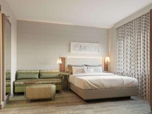 a bedroom with a large bed and a couch at Home2 Suites By Hilton New York Times Square in New York
