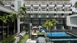 an external view of a hotel with a swimming pool at Sugar Marina Hotel - FASHION - Kata Beach in Kata Beach