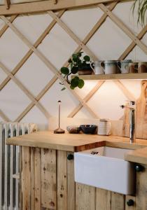 a kitchen with wooden walls and a wooden counter top at Tree Field Yurt at Moor Farm in Godshill
