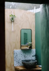 a bathroom with a sink and a mirror at Tree Field Yurt at Moor Farm in Godshill