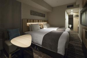 Tempat tidur dalam kamar di Hotel Sunroute Ginza