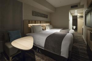 Postel nebo postele na pokoji v ubytování Hotel Sunroute Ginza