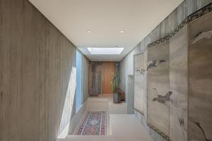 a hallway with wooden walls and a rug at 3902 Pacific Zen home in Carmel