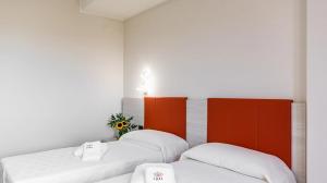 Postel nebo postele na pokoji v ubytování LUAL Bleisure Hotel