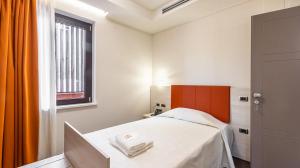 Postel nebo postele na pokoji v ubytování LUAL Bleisure Hotel