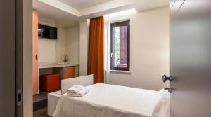 Postel nebo postele na pokoji v ubytování LUAL Bleisure Hotel