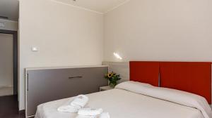 Postel nebo postele na pokoji v ubytování LUAL Bleisure Hotel