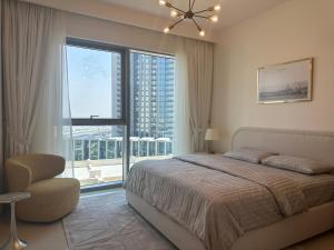 a bedroom with a bed and a large window at ROYAL APARTMENTS DUBAI in Dubai +202 photos