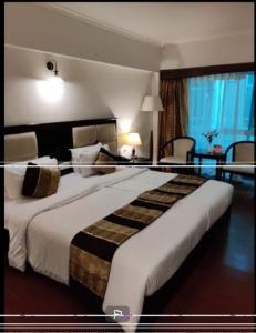 a bedroom with a large bed in a hotel room at Darjeeling La Resort in Darjeeling