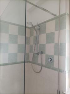 a shower in a bathroom with a glass door at Affitta camere Via Piave in Foligno