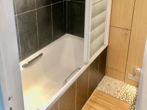 a shower with a glass door in a bathroom at Les Vallées La Défense in La Garenne-Colombes