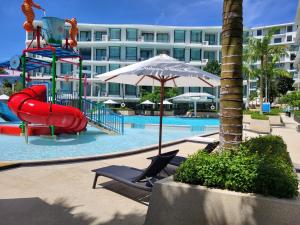 a pool with a water park with a slide at La Vita Phuket Rawai in Rawai Beach