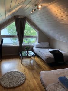 a attic room with two beds and a window at Bamse no 6 in Bodø