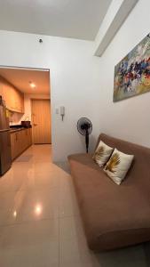 a living room with a couch and a kitchen at Studio Units at Shore Residences Condo MOA Complex near Airport in Manila