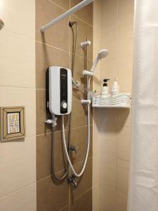 a shower in a bathroom with a shower dstg at ITCC Manhattan Suites by Pleasant Amenities in Donggongon