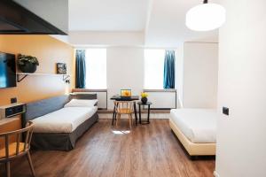 Postel nebo postele na pokoji v ubytování Aparthotel Colombo Roma