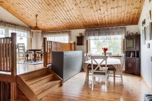 a kitchen with a table and a dining room at Unique cottage with a view of Malaren, Mariefred in Mariefred