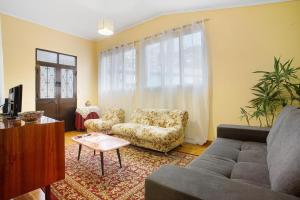 a living room with a couch and a chair at Casal Do Farrobo in Funchal