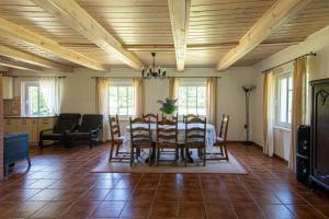 a dining room with a table and chairs at Dobilynė – privati ir jauki šeimos kurta sodyba 