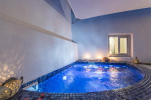 a large swimming pool in a house at Ambition Suites in Oia