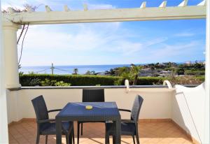 a patio with a table and chairs and a view of the ocean at Hotel Albatros in Ischia