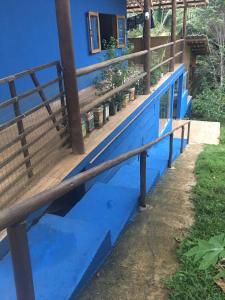 a blue bench in front of a blue house at Casa especial em Itacaré in Itacaré