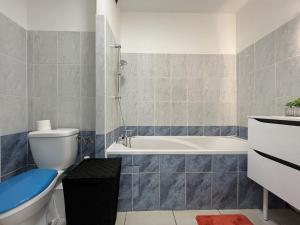 a bathroom with a toilet and a bath tub at Alexandrin, superbe appt avec varangue et vue mer pour 3 personnes in Saint-Gilles les Bains
