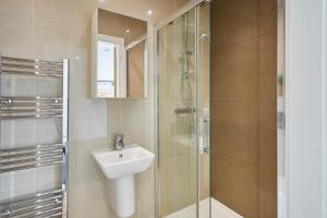 a bathroom with a sink and a glass shower at Host & Stay - The Knight Street Penthouses in Liverpool