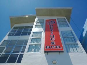 a building with a red hotel sign on it at BBoutique Hotel in Lapu Lapu City