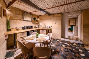 a kitchen with a table and chairs in a room at Arena View Premium Studio in Cluj-Napoca