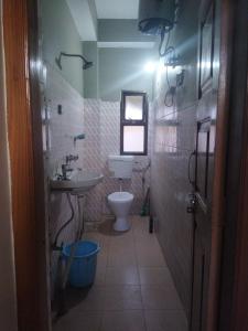 a bathroom with a sink and a toilet at OYO HOTEL RASU in Imphal