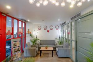 a waiting room with couches and a table at Hotel Asrani International in Secunderabad